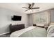 Bedroom features a large ceiling fan, gray walls and a bright window at 1146 N 89Th St, Mesa, AZ 85207