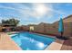 Sparkling pool area with clean blue water, a nearby patio and a privacy wall creating a private retreat at 1146 N 89Th St, Mesa, AZ 85207