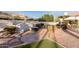 Landscaped backyard featuring a custom stone bench, fire pit, and winding stone pathway at 11628 S Warcloud Ct, Phoenix, AZ 85044