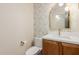 Well appointed powder room with designer wallpaper, vanity, mirror, and toilet at 11628 S Warcloud Ct, Phoenix, AZ 85044