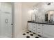 Bathroom features a double sink vanity, decorative tiles, and glass shower at 11628 S Warcloud Ct, Phoenix, AZ 85044