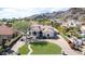 An aerial view of the home showcasing the landscape, paved driveway, and mountain views at 11628 S Warcloud Ct, Phoenix, AZ 85044