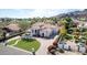 An elevated view of the home displays its manicured grounds, brick driveway, and mountain backdrop at 11628 S Warcloud Ct, Phoenix, AZ 85044