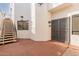 Exterior staircase leads to upper level with secure entry gate; outdoor lighting, security cameras, and courtyard at 11628 S Warcloud Ct, Phoenix, AZ 85044