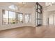 Bright foyer featuring a modern chandelier, hardwood floors, and a unique arched front door with sidelights at 11628 S Warcloud Ct, Phoenix, AZ 85044