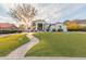 Stunning white home featuring pristine landscaping, a brick walkway, and manicured lawn at 11628 S Warcloud Ct, Phoenix, AZ 85044