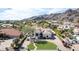 A gorgeous exterior of a home, featuring a circular driveway, desert landscape, and mountain views at 11628 S Warcloud Ct, Phoenix, AZ 85044