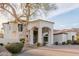 Beautiful white home with mature tree, a covered entryway, and brick driveway at 11628 S Warcloud Ct, Phoenix, AZ 85044