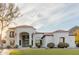 Beautiful white home featuring a grand entrance, lush lawn, and elegant landscaping at 11628 S Warcloud Ct, Phoenix, AZ 85044