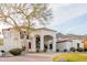 Stunning home with pristine landscaping, mature tree, and elegant brick driveway at 11628 S Warcloud Ct, Phoenix, AZ 85044