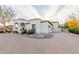 Gorgeous home featuring a circular driveway, manicured landscaping, and a tile roof at 11628 S Warcloud Ct, Phoenix, AZ 85044