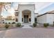 Inviting front exterior with lush landscaping and a circular brick driveway at 11628 S Warcloud Ct, Phoenix, AZ 85044