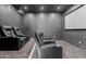 Home theater with reclining leather seats, projector, and surround sound at 11628 S Warcloud Ct, Phoenix, AZ 85044