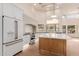 Modern kitchen with stainless steel appliances, white cabinets, and large island with quartz countertops at 11628 S Warcloud Ct, Phoenix, AZ 85044