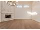 Living room showcasing fireplace, chandelier, and tall ceilings with hardwood floor at 11628 S Warcloud Ct, Phoenix, AZ 85044