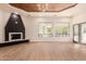 Bright living room with hardwood floors, a corner fireplace, and sliding doors to the backyard at 11628 S Warcloud Ct, Phoenix, AZ 85044