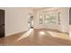 Bright and airy living room featuring hardwood floors and large windows with natural light at 11628 S Warcloud Ct, Phoenix, AZ 85044