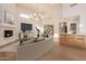 Living room showcases a stone fireplace, bar area, and modern chandelier at 11628 S Warcloud Ct, Phoenix, AZ 85044