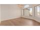 Bright living room showcasing ample natural light, neutral walls, and hardwood floors at 11628 S Warcloud Ct, Phoenix, AZ 85044