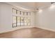 Bright living room featuring a large bay window, neutral walls, and hardwood floors at 11628 S Warcloud Ct, Phoenix, AZ 85044