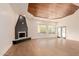 Open-concept living room with a fireplace, hardwood floors, and lots of natural light at 11628 S Warcloud Ct, Phoenix, AZ 85044