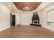 Spacious main bedroom with a fireplace, wood tray ceiling, and neutral decor at 11628 S Warcloud Ct, Phoenix, AZ 85044