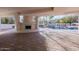 Covered patio with fireplace and brick pavers overlooks a backyard pool, waterfall, and lush landscaping at 11628 S Warcloud Ct, Phoenix, AZ 85044