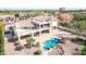 An elevated shot features a sparkling pool, a covered patio, and verdant landscaping at 11628 S Warcloud Ct, Phoenix, AZ 85044