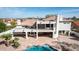 Aerial view features the home's private pool, rock features, and a spacious covered patio at 11628 S Warcloud Ct, Phoenix, AZ 85044