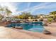 Resort style pool featuring waterfalls, a rock-lined grotto, and lush desert landscaping at 11628 S Warcloud Ct, Phoenix, AZ 85044