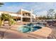 A gorgeous inground pool with a spa, rock features, and a multi-story home in the background at 11628 S Warcloud Ct, Phoenix, AZ 85044