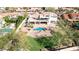 Aerial view of luxurious home featuring a covered patio, swimming pool, and lush green landscaping at 11628 S Warcloud Ct, Phoenix, AZ 85044