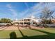 Stunning home exterior featuring a lush lawn, decorative rocks, and a spacious covered patio at 11628 S Warcloud Ct, Phoenix, AZ 85044