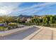 Rooftop view capturing a landscape with palm trees, desert landscaping, and majestic mountains at 11628 S Warcloud Ct, Phoenix, AZ 85044