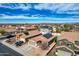 Community showcases a view of well-maintained homes with desert landscaping and a clear blue sky at 11954 W Melinda Ln, Sun City, AZ 85373