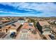 Bird's-eye view of a residential area with solar panels on multiple homes, showcasing community energy efficiency at 11954 W Melinda Ln, Sun City, AZ 85373