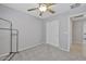 Carpeted bedroom with a closet, ceiling fan, and neutral walls that offers comfort and convenience at 11954 W Melinda Ln, Sun City, AZ 85373