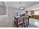 Cozy dining area featuring a rustic chandelier, tile flooring, and natural light at 11954 W Melinda Ln, Sun City, AZ 85373