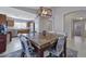 Bright dining area features a marble-top table, modern lighting fixture, and convenient access to the kitchen at 11954 W Melinda Ln, Sun City, AZ 85373