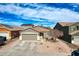 Single-story home with desert landscaping, a two-car garage, and tile roofing, topped by a bright blue sky with light cloud cover at 11954 W Melinda Ln, Sun City, AZ 85373