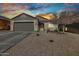 Single-story home showcasing a desert landscape and neutral color palette with a two car garage and tile roof at 11954 W Melinda Ln, Sun City, AZ 85373