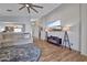 Spacious living room featuring hardwood floors, recessed lights, a ceiling fan, and a wall-mounted television at 11954 W Melinda Ln, Sun City, AZ 85373