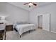 Comfortable main bedroom with vaulted ceiling, ceiling fan, dresser, and adjacent open door at 11954 W Melinda Ln, Sun City, AZ 85373