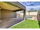 Cozy patio view with artificial grass, concrete, outdoor lighting, and shed at 11954 W Melinda Ln, Sun City, AZ 85373