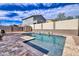 Backyard swimming pool with spa and desert landscaping, surrounded by brick walls at 11954 W Melinda Ln, Sun City, AZ 85373