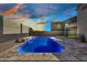 Gorgeous backyard pool with stone features, set in a private yard with block fence and desert landscaping at 11954 W Melinda Ln, Sun City, AZ 85373