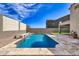 Backyard pool with water feature, desert landscaping, and covered patio at 11954 W Melinda Ln, Sun City, AZ 85373