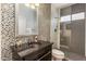 Chic bathroom featuring decorative tilework, black fixtures, and a modern sink with sleek hardware at 12026 N 138Th St, Scottsdale, AZ 85259