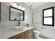 Modern bathroom featuring marble walls, a sleek vanity with vessel sink, black accents and natural light at 12026 N 138Th St, Scottsdale, AZ 85259