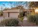 Home exterior features mature desert landscaping and attached three car garage at 12026 N 138Th St, Scottsdale, AZ 85259